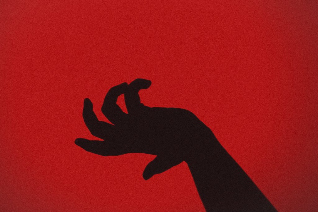 what does counterfeit mean? image of a red hand contorting