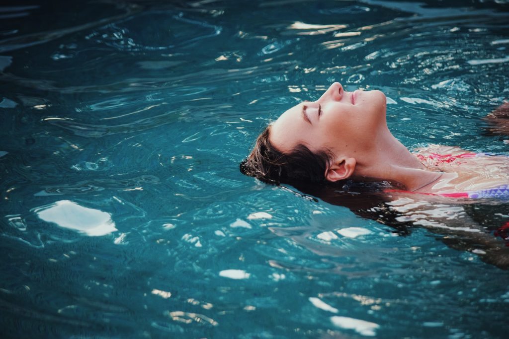 IP Legal Costs - A Guide. Image of a lady relaxing with the head in blue water.