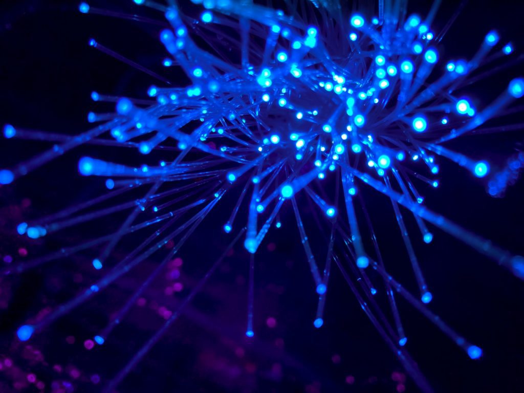 IP Legal Costs, An Image of fluorescent fibre optic lights, allegorical of the internet