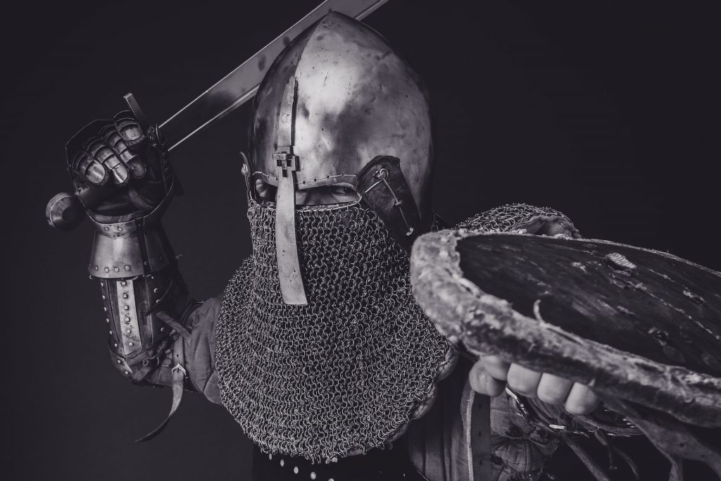 Defending your business against IP infringement - image of a person in chainmail armour poised to attack