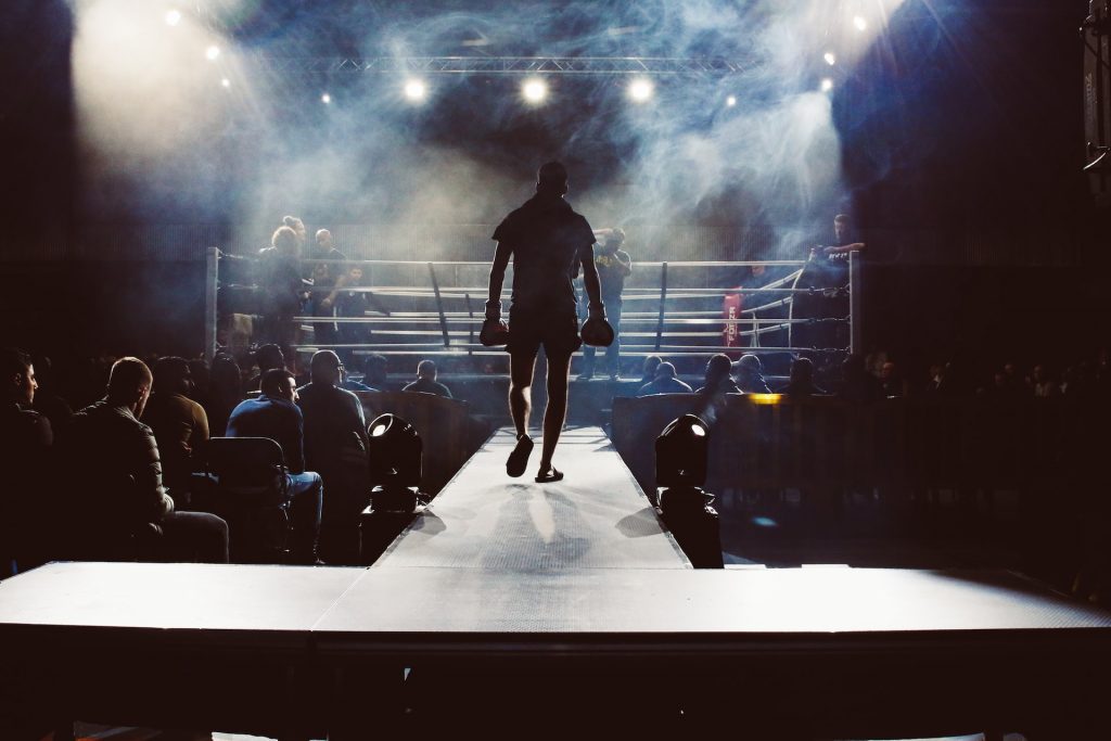 Image of a sillhouette of a boxer approaching the ring