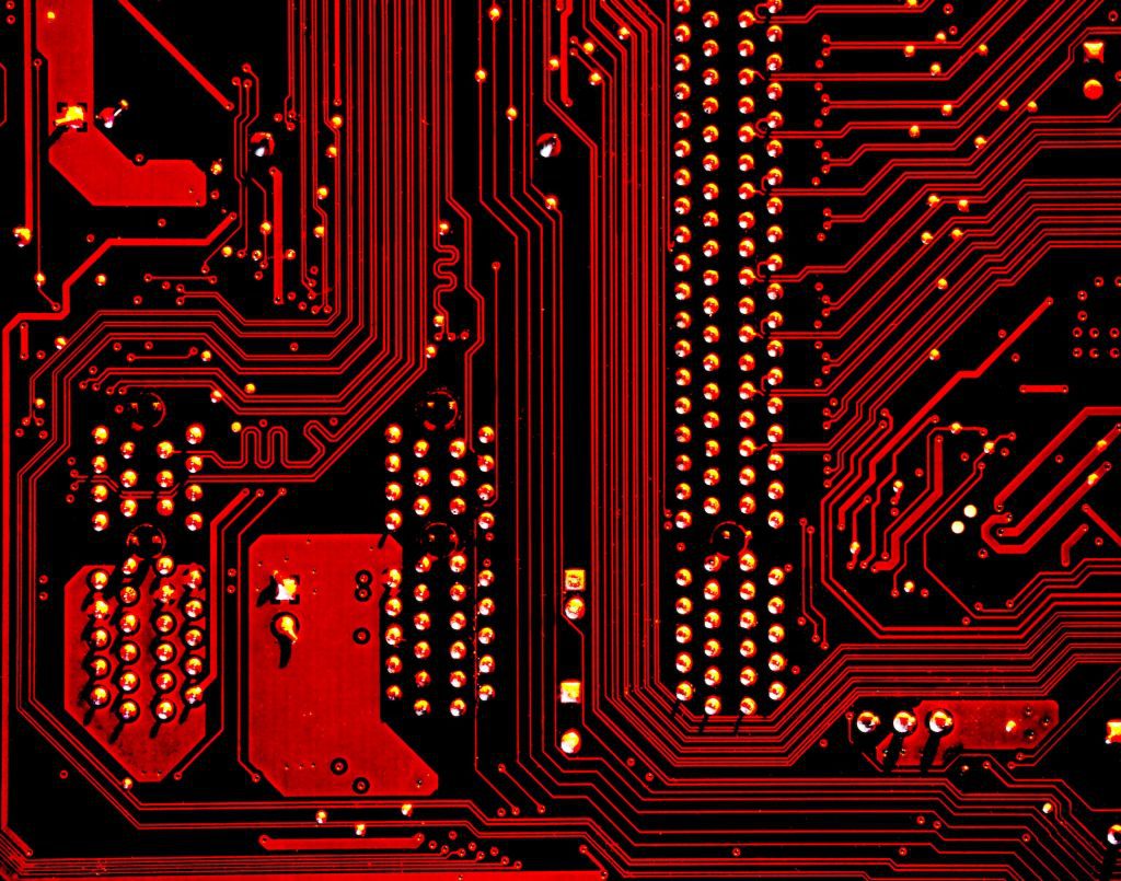 IP law and cybersecurity - image of a computer board, red with yellow accents