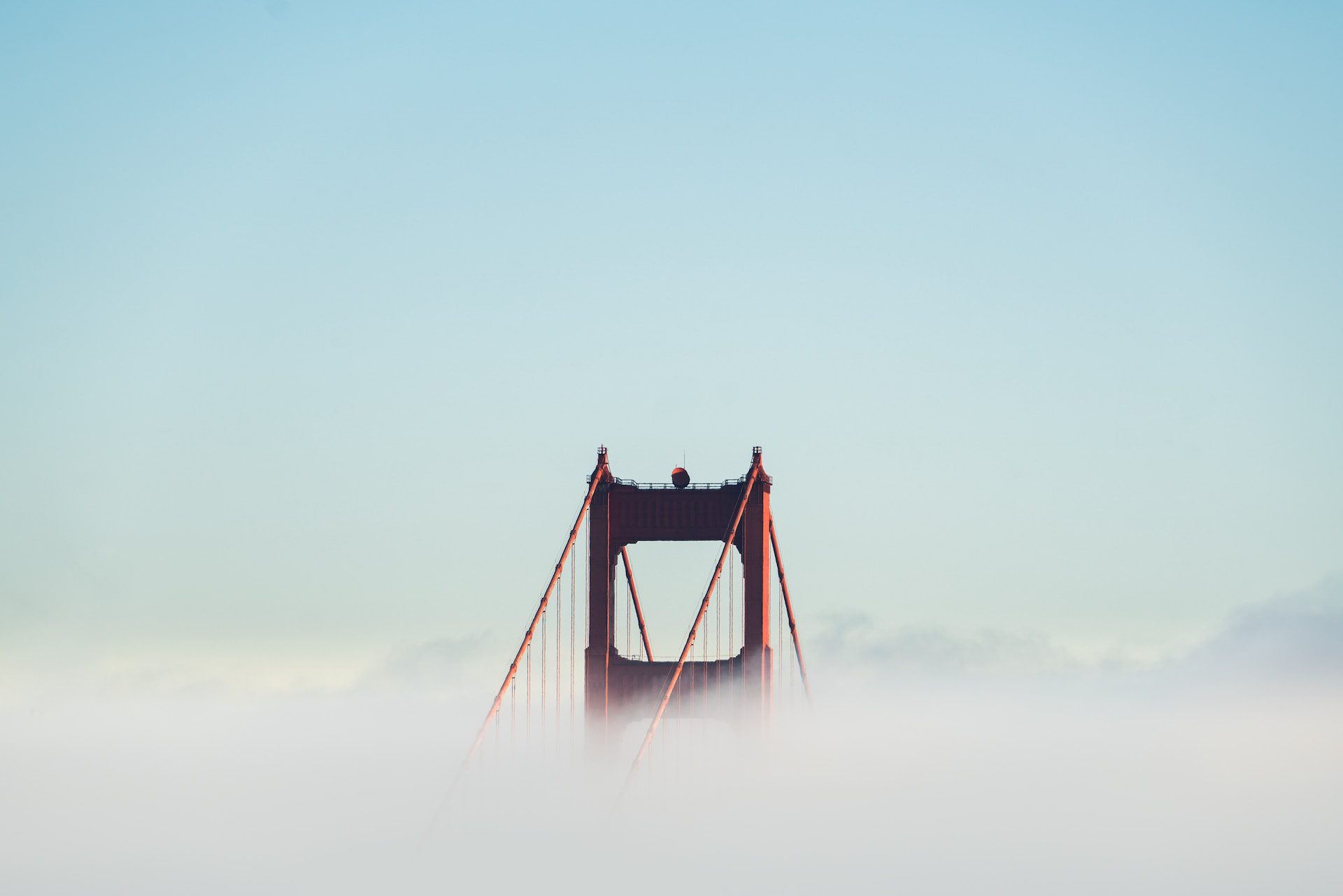 It's the Golden Gate bridge, popping up over the clouds. Visual metaphor.